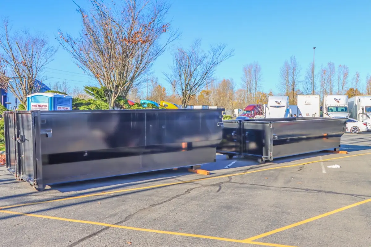 Professional dumpster rental service with roll-off container on residential driveway in Hazelwood